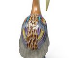 a figurine of a bird that is standing on a rock