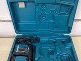 a blue tool box with a drill and a charger in it