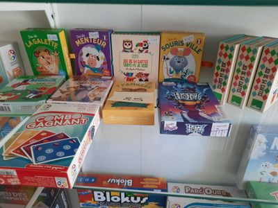 many boxes of games on a shelf in a store