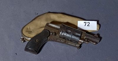 an old revolver with a tag on it sitting on a table