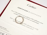 a certificate with a ring on top of it on a table