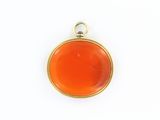 a gold and carneline pendant on a white background