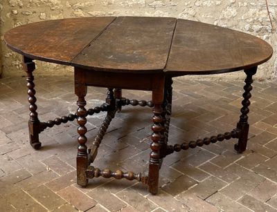 a wooden table with a wooden top on a brick floor
