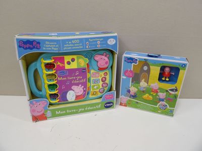 two pep the pig toys are in a box on a table