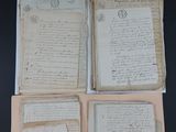 several old papers sitting on top of each other on top of a table