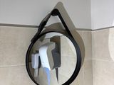 a mirror hanging on the wall above a sink