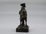 bronze statue of a rooster on a marble base
