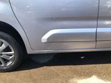 a silver van parked in a parking lot next to a parking meter