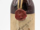 a bottle of wine with a wax stamp on it