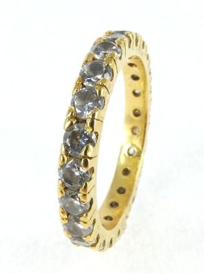 a close up of a yellow gold ring with black diamonds