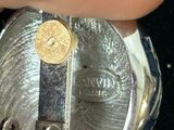 a person that is holding a watch in their hand