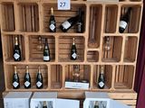 several bottles of wine are on display in a wooden crate