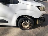 a white van with a flat tire on the side of the road