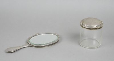 a small glass jar with a mirror and a spoon