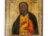 an old wooden icon of a bearded man holding a cross