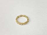 a close up of a gold ring on a white surface