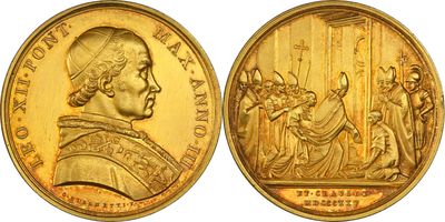 a close up of a gold coin with a picture of a man on it