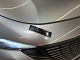 a close up of a car ' s headlight with a sticker on it