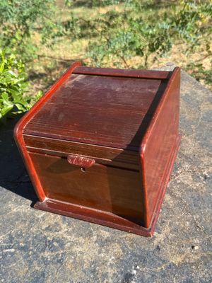 an old wooden box sitting on top of a cement slab