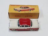 toy car in a box on a white surface with a red roof
