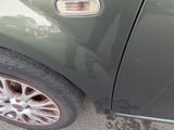 a close up of a car ' s tire on the side of the road
