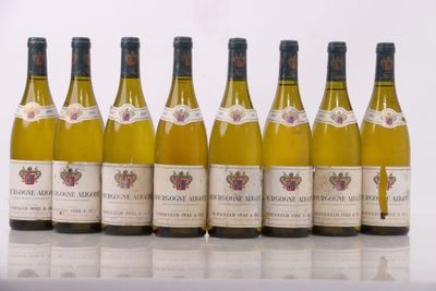 six bottles of wine are lined up in a row on a table