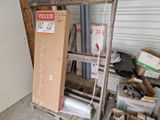 a stack of boxes sitting on a shelf in a garage