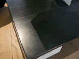 a black table with a laptop on top of it