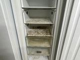 a white refrigerator that is open in a kitchen
