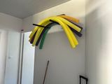 a room with a bunch of different colored tubes hanging on the wall
