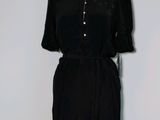 a picture of a black dress on a mannequin stand