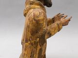 a wooden figurine of a man with a beard and a hat