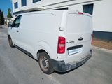 a white van parked in front of a building
