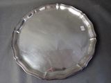 a silver plate on a table with a black table cloth