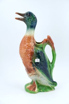 a small vase with a bird on it on a white surface