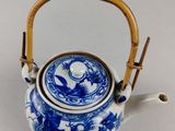 blue and white porcelain teapot with bamboo handle and handle