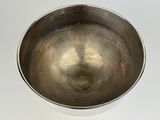 a silver bowl on a white surface with a white background