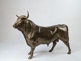 bronze statue of a bull on a white background