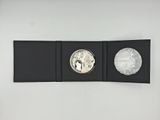 a close up of a coin in a black box on a white surface