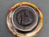 a close up of a rusted metal object on a table