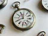 a close up of a pocket watch on a table