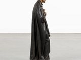 a statue of a man in a black cloak and hat