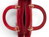 a close up of a red handbag on a white surface