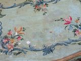 a table with a floral design on it in a room