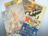 a lot of postcards that are on a table