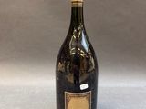 an old bottle of wine sitting on top of a table