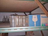 a shelf that has a bunch of empty glassware on it