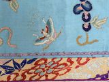 three pieces of blue and red embroidered fabric with a dragon and flowers design
