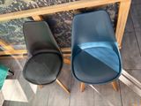 two chairs sitting next to each other on a tiled floor
