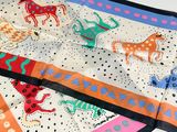 a close up of a scarf with animals on it